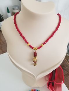 This historic and authentic sparkle red crystal necklace is the perfect gift for Valentine's Day, birthdays, or any special occasion. The necklace features a beautiful red crystal and a tiny golden heart charm, adding a touch of elegance and romance to any outfit. The necklace also features golden beads for added sparkle. Weighing in at only 20 grams, it is lightweight and easy to wear, making it perfect for everyday wear. It's also 44-48 cm (adjustable) in length. Give this necklace as a gift to a loved one and show them how much you care. It is also a great gift for any woman who loves sparkle and elegance in her jewelry. Surprise your loved one and make them feel special! Thank you so much for visiting and hope you enjoy shopping with us! ♥ Odinyo Family Red Faceted Spiritual Jewelry, Spiritual Red Jewelry For Christmas, Ruby Beaded Necklaces As Gift, Red Faceted Pendant Necklaces, Red Faceted Pendant Necklace, Spiritual Gemstone Beads Jewelry For Valentine's Day, Red Spiritual Pendant Crystal Necklaces, Red Spiritual Crystal Pendant Necklace, Spiritual Red Crystal Pendant Necklace