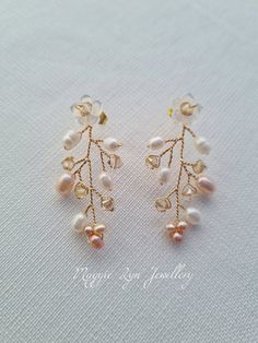 Truly beautiful bridal earrings, with a drop of approximately 4.5cm. Handmade with hand carved Mother of pearl flowers, quality natural ivory and blush pink freshwater pearls with the finest quality champagne crystals set on a Gilt gold plated, copper wire showing intricate detailing. All of our items are made to order so adjustments can be made with regards to materials and designs. Please message us if you require different specifications.  The design is handmade featuring natural freshwater p Pearl White Flower Earrings For Pierced Ears, Pearl White Flower Earrings, Pearl Flower Dangle Earrings For Pierced Ears, Handmade Delicate Pearl Earrings, Elegant Pierced Cluster Earrings For Wedding, Delicate Pearl Dangle Earrings, Delicate Dangle Pearl Earrings, Pearl White Flower Earrings Set, Flower Shaped Pearl Drop Jewelry For Anniversary