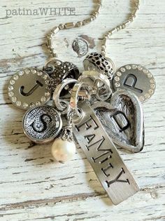 a necklace with charms and letters on it