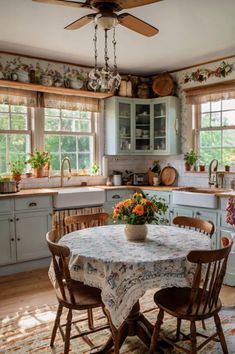 a kitchen with a table, chairs and a ceiling fan in the middle of it