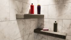 two vases are sitting on the shelf in the bathroom, next to each other