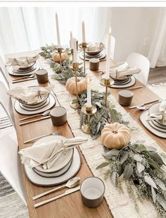 the table is set with candles and plates