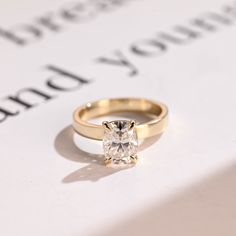 a diamond ring sitting on top of a piece of paper