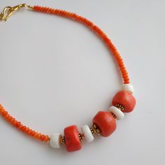 < Orange and white coral beaded necklace > This product made according to the model of authentic traditional Ukrainian jewelry. The coral is modern, the design is vintage. Like 99% of the coral on the market these days, this coral has been dyed. I use bamboo coral which is not endangered or threatened in any way, unlike natural pink or red coral (the production of which is forbidden almost everywhere in the world). Bamboo coral doesn't mean it's not organic. Every bead of it has a distinct Orange Red Coral Beaded Necklace With Large Beads, Orange Red Coral Beaded Necklaces With Large Beads, Orange Beaded Necklace With Large Red Coral Beads, Traditional Coral Beaded Necklaces With Colorful Beads, Handmade Red Coral Beads For Jewelry Making, Handmade Red Coral Beads, Handmade Red Coral Round Beads, White Artisan Beaded Necklaces With Oval Beads, Artisan White Beaded Necklace