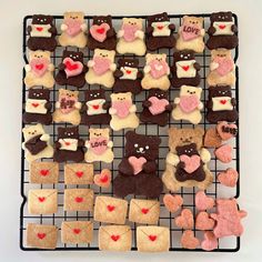 a wire rack filled with lots of decorated cookies