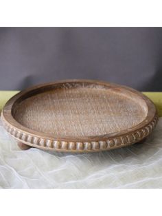 a wooden tray sitting on top of a white cloth covered tablecloth next to a banana