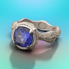 a ring with a blue stone in the center on a blue background and an intricate filigree design