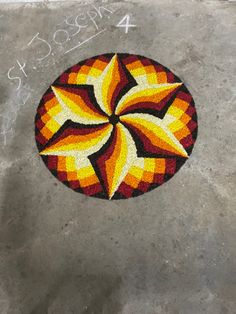 a colorful design on the ground with chalk writing