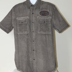 Nwt Affliction Premium Black Label Live Fast Buttons Down Shirt 100% Guaranteed Authentic Size Large Color Dark Short Sleeves Full Length Buttons Placket Chest Flap Pockets Embroidered Patch On Chest Huge Graphic With Embroidery On Back Regular Fit Slightly Rounded Hem 100% Cotton Spare Buttons Attached To Care Instructions Measurements Size Armpit To Armpit Length L 23 ½ In 32 In Distressed Collared Cotton Top, Distressed Cotton Collared Tops, Rugged Cotton Pre-washed Shirt, Rugged Pre-washed Cotton Shirt, Casual Pre-washed Cotton Shirt, Distressed Fitted Casual Shirt, Rugged Washed Cotton Tops, Rugged Cotton Shirt, Fitted Distressed Casual Shirt