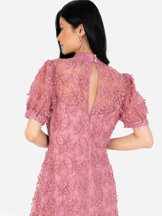 + dusty pink color+ intricate lace detailing + subtle sequins throughout+ mock neckline+ button closure at sleeves+ mid-axi length with tiered hem High Neck Lace Dress With Lace Sleeves, High Neck Lace Dress With Lace Trim, High Neck Dresses With Lace Sleeves, Elegant Pink Midi Dress With Lace Patchwork, High Neck Evening Dress With Lace Trim, High Neck Dress With Lace Trim, Party Dress With High Neck And Lace Sleeves, High Neck Party Dress With Lace Sleeves, High Neck Lace Sleeves Party Dress