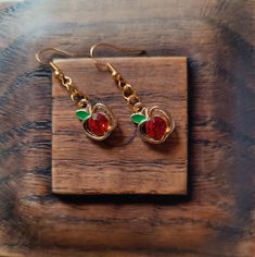 Adorable Dangly Earrings | Handmade Boho Jewelry | Lightweight Earrings Add some juicy shine with these vibrant gorgeous dangly earrings! Handcrafted with love, these earrings are designed to make a statement while remaining lightweight and comfortable for all-day wear.  ✨ Features: Beautifully simple design: Golden apple with shiny red jewel that sparkles and green enamel leaf Lightweight and comfortable: Perfect for everyday wear or special occasions. Versatile style: Dress them up or down for Earrings Handmade Boho, Handmade Boho Jewelry, Red Jewel, Golden Apple, Gold And Red, Lightweight Earrings, Dangly Earrings, Green Enamel, Etsy Earrings Dangle