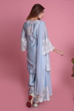 Powder blue straight kurta with all-over floral motif applique-dori work and scallop hem. Comes with sharara pants and tassel dupatta.
Component: 3
Embroidered
Neckine: Round
Sleeve Length: Three Quarter
Fabric: Kurta and Pant: Silk Chanderi; Dupatta: Chiffon
Color: Blue
Side slits
Tassel dupatta
Flared sleeves
Keyhole neck - Aza Fashions Blue Organza Sharara With Chikankari Embroidery, Blue Chikankari Embroidered Sharara For Reception, Blue Chikankari Embroidery Palazzo Set For Reception, Blue Palazzo Set With Chikankari Embroidery For Reception, Festive Light Blue Sharara With Chikankari Embroidery, Unstitched Blue Organza Sharara, Light Blue Chikankari Embroidered Sharara For Wedding, Blue Sharara With Floral Embroidery In Traditional Drape, Blue Silk Palazzo Set With Intricate Embroidery