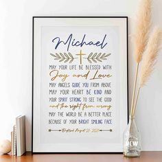 a framed print with the words michael on it next to a vase filled with flowers