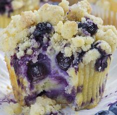 blueberry muffins with crumbs on a paper plate, ready to be eaten