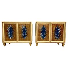 pair of art deco nightstands with blue starburst design on the front and sides