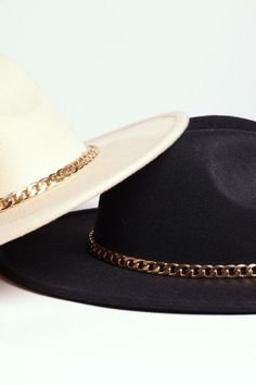 Elevate Your Style with Our Fedora Hat Featuring a Chic Chain Accent Step up your accessory game with this stylish fedora, designed for the modern fashionista who loves to make a statement. Crafted from high-quality materials, this structured fedora boasts a sleek, timeless silhouette with a twist – a bold, gold-tone chain detailing around the crown that adds just the right touch of luxe. Whether you're pairing it with a casual jeans-and-tee combo or elevating a business-casual look, this fedora