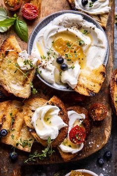 an assortment of breads with cream cheese and olives