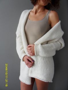 "Luxury, amazingly soft, oversized alpaca knit sweater cardigan . The pattern has relaxed fit with dropped shoulders. Color is off white. For colors available in pearl /light grey, black/charcoal, brown, crem/wheat, blue /green, burgundy, violet and pink click here https://www.etsy.com/ca/listing/187868895/alpaca-chunky-knit-woman-cardigan?ref=related-1 A new and exciting \"blow yarn\" made from soft 72% Baby Alpaca and cozy Merino wool. Its construction is unique, based on the newest yarn techn White Oversized Cozy Sweater, Oversized White Cozy Sweater, Long White Soft Knit Sweater, White Long Soft Knit Sweater, Cozy White Sweater Coat For Winter, Cozy White Winter Sweater Coat, White Chunky Knit Sweater Coat For Winter, Cozy Knit Sweater Coat In Winter White, Cozy Long Cream Cardigan