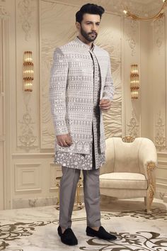 This men's sherwani, style U2-S351, features an open jacket design and intricate thread work. Offering a traditional and elegant look, this sherwani adds a touch of sophistication to any occasion. Expertly crafted, it exudes quality and fine craftsmanship. Elevate your style with this stunning piece. Elegant Designer Suits With Intricate Embroidery, Elegant Bandhgala With Chikankari Embroidery For Designer Wear, Elegant Designer Festive Outerwear, Elegant Festive Designer Outerwear, Elegant Suits With Chikankari Embroidery For Designer Wear, Elegant Sherwani With Chikankari Embroidery For Designer Wear, Elegant Designer Outerwear For Diwali, Elegant Chikankari Embroidery Suits For Designer Wear, Formal Sherwani With Intricate Embroidery And Traditional Drape