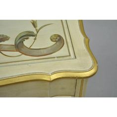 an ornately painted table with gold trim