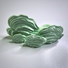 a green object sitting on top of a white table