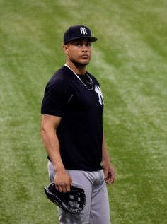 a baseball player standing in the outfield with his mitt and ball glove on