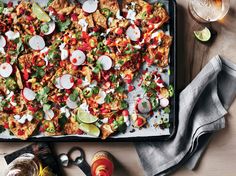 a tray filled with nachos and salsa on top of a table