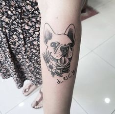 a woman with a dog tattoo on her arm