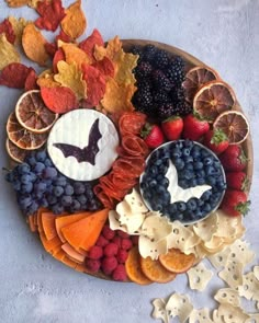 a platter filled with fruit and crackers