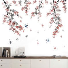 the wall is decorated with flowers and birds on it's branches, which are painted in