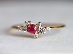 Ruby engagement ring, Genuine ruby ring, Cluster engagement ring, Ruby cluster ring, Cluster ring with ruby and diamond, Ruby ringAvailable in 9k/14k/18k yellow, rose or white gold. Same design can be made also with other custom gemstones per request. Product details:- Solid gold- Diamond - 1.5mm, 2mm, 2.5mm, Ruby - 3mm- 1.1mm band- Diamond clarity - VS, Color - E-FRing size - US 3 to US 9 (for smaller or larger ring size, please contact)Please select your size at the drop down menu. Service Ava Ruby And Diamond Cluster Ring, Ruby Cluster Ring For Promise, Ruby Cluster Ring For Promise Occasion, Cluster Diamond Ruby Promise Ring, Ruby And Diamond Cluster Promise Ring, Cluster Diamond Ruby Ring For Promise, Fine Jewelry Cluster Ruby Promise Ring, Cluster Diamond Ring With Birthstone For Gift, Cluster Diamond Ring With Birthstone As Gift