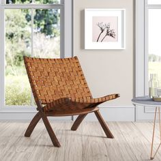 a wooden chair sitting in front of a window