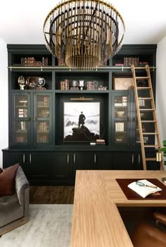 a living room filled with furniture and a chandelier hanging from the ceiling above it