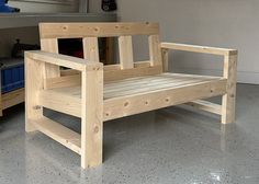 a wooden bench sitting on top of a cement floor