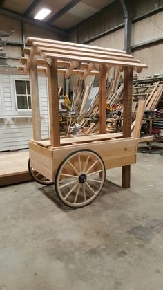 a wooden cart with wheels in a garage