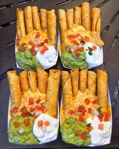 four trays filled with different types of food on top of each other, including tortilla shells and guacamole