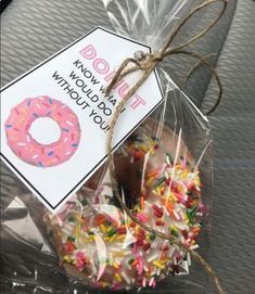 a bag filled with donuts and sprinkles on top of a table