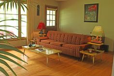 a living room filled with furniture and a large window next to a wooden coffee table