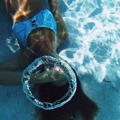 a person swimming in the water with a ring around their neck