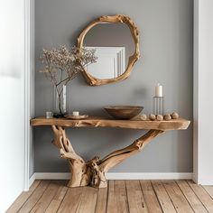 a wooden table with a mirror and vase on it