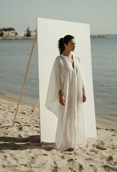 Gaia Linen Dress in White Elegant White V-neck Kaftan, White V-neck Maxi Dress For Loungewear, Chic Oversized Kaftan For Beach Cover-up, Chic White Maxi Dress For Loungewear, Elegant Flowy Beach Dress For Daywear, Spring Linen V-neck Kaftan, White Relaxed Fit Maxi Dress For Loungewear, White Oversized V-neck Kaftan, Elegant Flowy Maxi-length Cover-up