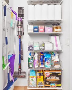 the closet is filled with cleaning supplies and other household care items, including a vacuum cleaner