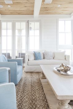 a living room filled with furniture and white walls