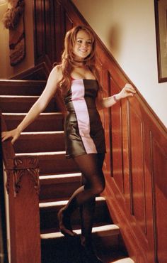 a woman in tights and heels standing on the stairs