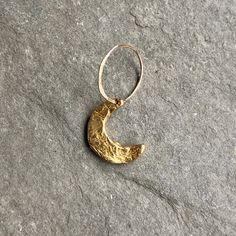 A crescent moon charm dangles from a lightly hammered jump ring. Add your celestial charm to your birthstone cluster necklace. Length 3/4" Width 1/2" Stamp upto 1 character on full moon charm Our crescent moon, star, full moon and ellipse charms are available in brass and sterling silver. Pair with a brass or sterling silver chain and birthstone charm. Each charm is sold separately. Brass Moon Charm Jewelry, Hand Forged Moon-shaped Gold Jewelry, Hand Forged Moon Shaped Gold Jewelry, Gold Hammered Half Moon Jewelry, Hammered Gold Half Moon Jewelry, Crescent Moon Phase Brass Jewelry, Crescent Moon Charm For Jewelry Making, Celestial Crescent Moon Charm Jewelry, Crescent Moon Charm Jewelry For Jewelry Making