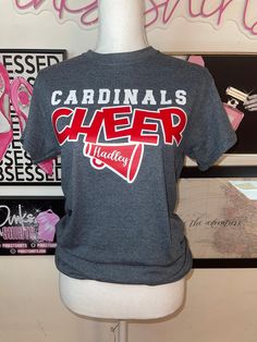 a t - shirt with the words cardinals cheer on it sitting on a mannequin