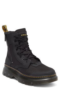 The label's Original boot gets reimagined for contemporary utility in a hybrid construction of lightweight Ajax leather and Extra Tough 50/50 fabric.The cemented Tarian lug sole is finished with DM's iconic yellow topstitching. 2" platform, 6" shaft (size 9) Lace-up style; side zip closure Textile and leather upper/leather lining/synthetic sole Imported Black Urban Combat Boots With Round Toe, Urban Black Combat Boots With Round Toe, Rugged Black Combat Boots With Reinforced Heel, Black Leather Urban Combat Boots, Urban Black Leather Combat Boots, Urban Black Lace-up Combat Boots, Black Lace-up Urban Combat Boots, Urban Black Combat Boots For Fall, Black Moto Boots With Vibram Sole For Outdoor Work