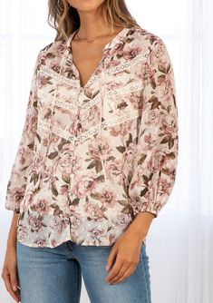 For the romantic at heart, our sheer floral print blouse is full of dreamy details. With long voluminous sleeves, pretty lace trim detail across the front, and delicate clip dot details throughout. A stunning style that pairs effortlessly with denim. FINAL SALE Floral print Relaxed fit Long voluminous sleeve Elastic wrist cuff Split neckline with ties Self-covered button front Lace trim detail across the front Clip dot detail throughout Sheer Removable lining Peasant top Model is 5'9, wearing a Feminine Blouse With Ditsy Floral Print, Feminine Floral Print Blouse For Daywear, Bohemian Lace Top With Floral Print, Spring Feminine Blouse With Lace Trim, Feminine Lace Trim Blouse For Spring, Lace Floral Print Tops For Daywear, Lace Tops With Floral Print For Daywear, Feminine Long Sleeve Blouse With Lace Trim, Feminine Spring Blouse With Lace Collar