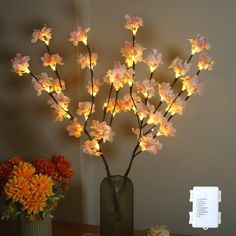 a vase filled with flowers sitting on top of a table next to a cupcake