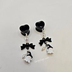 🖤🐄You'll Receive One Pair Of These Drop/ Dangle Tunnels: All Black Acrylic Heart Tunnel Plugs With Iridescent Beads Attached to A Black Matte Bow And A Kawaii Dainty Ghost Pendant. Will be done in Acrylic Heart Double Flared Tunnels sizes 0g-1"  👻MATERIALS USED VARIES DEPENDING ON YOUR PLUG SIZE! ↓ Sizes 0g-1/2": Will Be Done In ACRYLIC DOUBLE FLARED Tunnels ◼️Sizes Available Are 0g (8mm) , 00g (10mm), 1/2"(12mm) 9/16" (14mm), 5/8 (16mm), 3/4 (18mm), 13/16" (20mm), 7/8 (22mm), 1" (25mm) --------------------------------------- 🖤WE MAKE EARRINGS TOO!  Via Fake Plug Option In The Drop Box.  These Will Be Made In Cheater Plug Style. They Have Two Acrylic Bases Connected To A 316L  Surgical Steel Post That You Can Screw On To Wear. This Post Measures 16GA / 1.2mm & Is Made To Look Like 0GA/ Cheap Hypoallergenic Dangle Plug Earrings, Harajuku Style Black Jewelry, Cute Black Hypoallergenic Jewelry, Harajuku Style Halloween Jewelry Gift, Kawaii Black Jewelry Gift, Black Novelty Jewelry For Valentine's Day, Black Themed Jewelry For Valentine's Day, Whimsical Black Jewelry For Gifts, Themed Black Jewelry For Valentine's Day